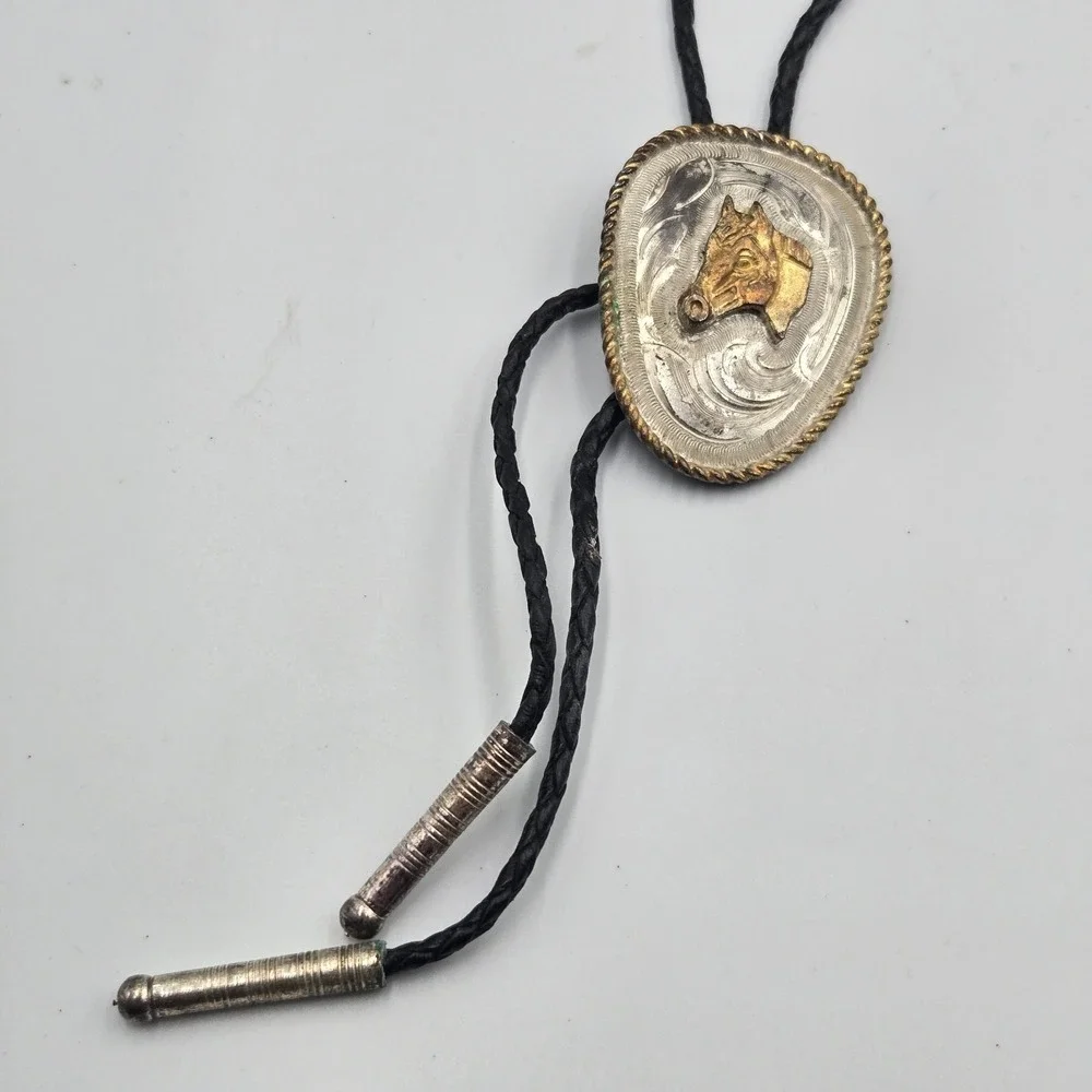 Vtg Southwestern Bolo Tie Silver Gold Tone Horse Head Black Braided Cord‎